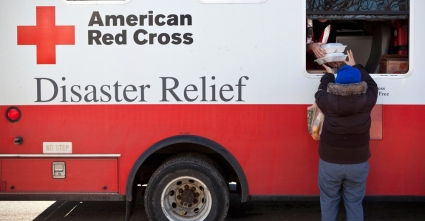 Image: A woman receives warm meals from a Disaster Relief truck run by the American Red Cross in the Midland Beach neighborhood in Staten Island